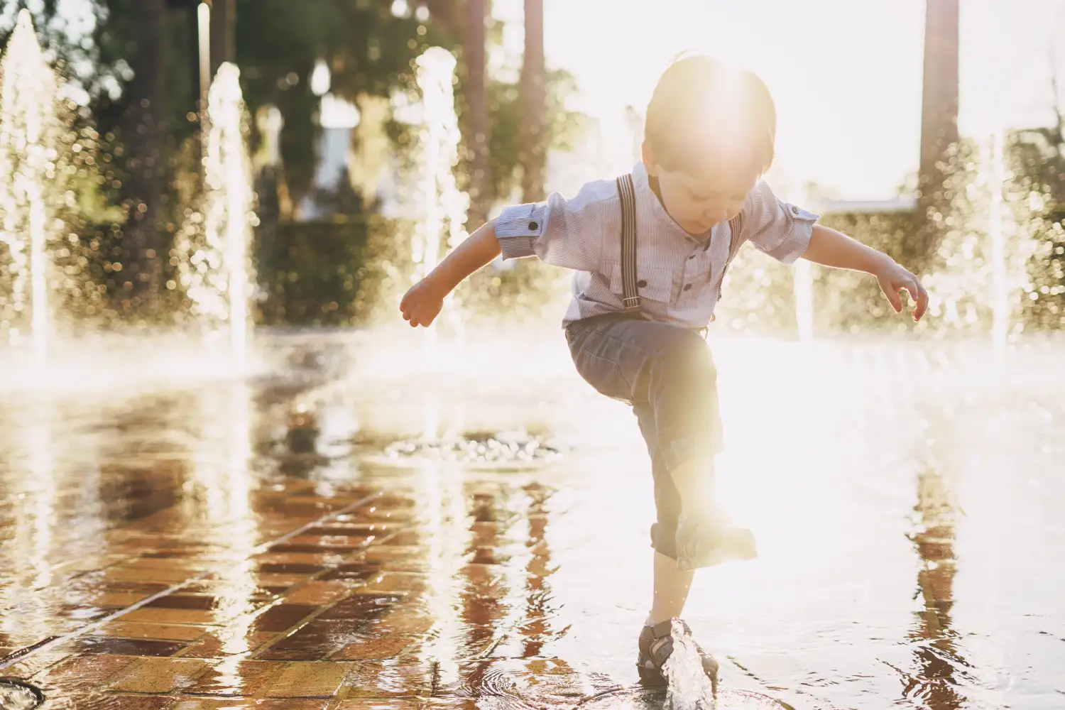 Young child playing in water representing kids therapy support at Blue Shores Counselling in Collingwood and Stayner.